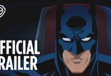 Batman animado de máscara azul olha de frente, com a inscrição Official Trailer